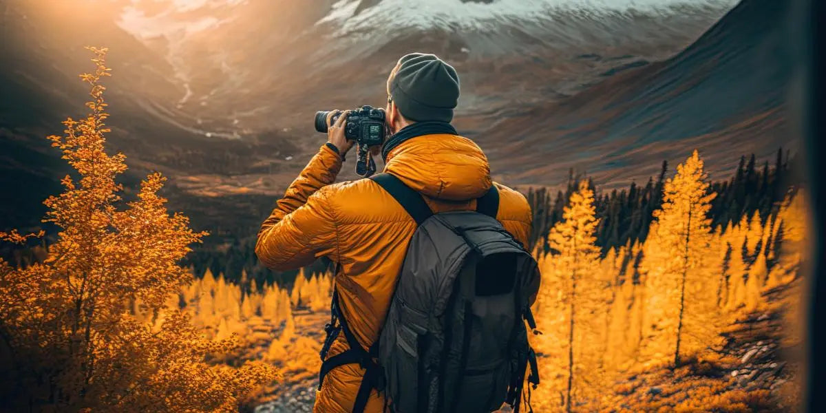 A man with binoculars in the mountains.