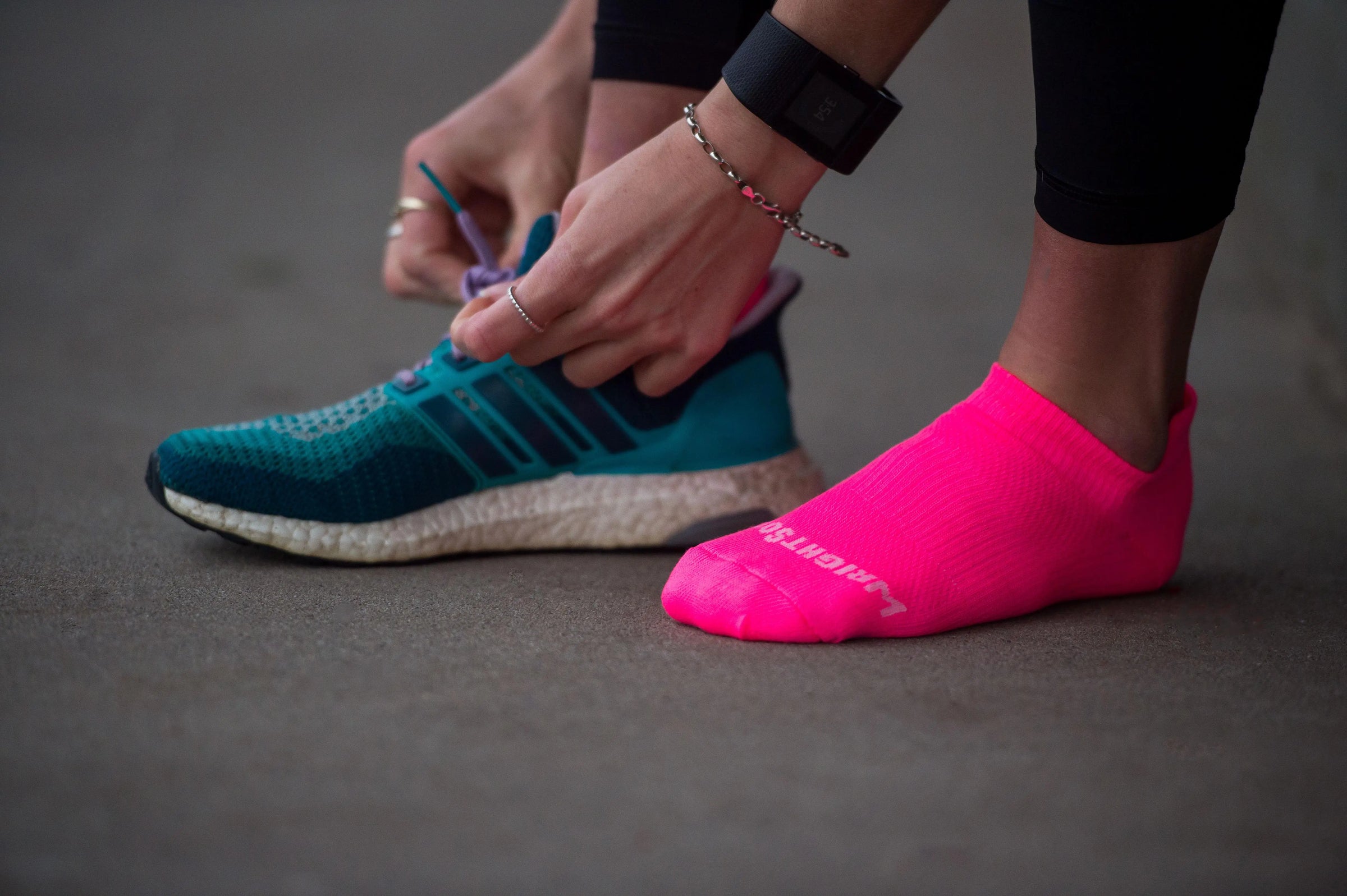 woman tying shoes with blister free socks